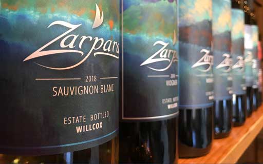 Row of Zarpara wine bottles on a shelf